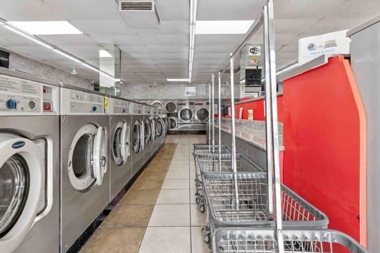 Laundromat with a row of washing machines at 24/7 laundry near USC